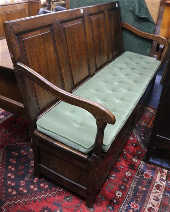 A mid 18th century oak box seat settle W.153cm